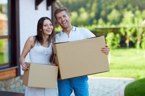 Trained movers handling furniture with PPE in Westminster