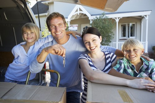 Removal team handling household items in a central London property